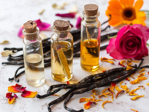 Set of three glass jars with vanilla pods and dried calendula and rose petals
