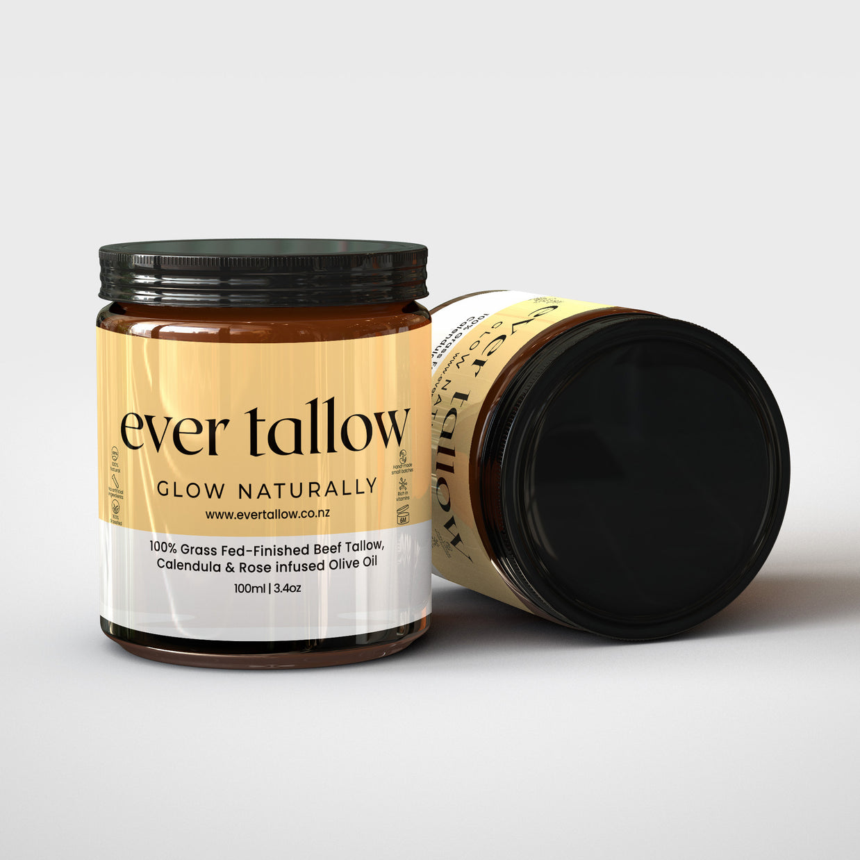 Two jars of Beef_Tallow_Calendula_and_Rose_infused_Olive_Oil. One jar is on its side.