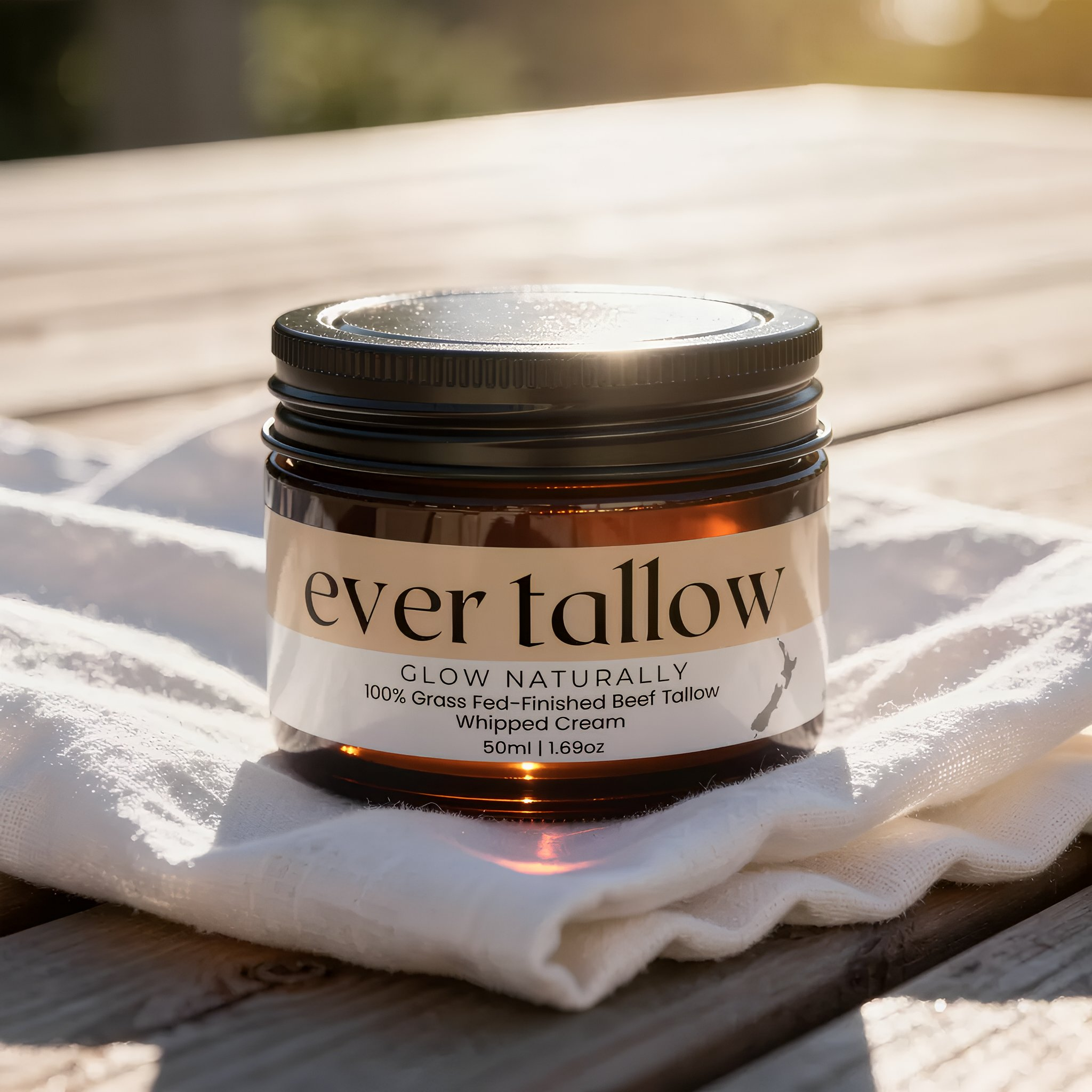 Jar of 'ever tallow' cream on a white cloth with a blurred natural background