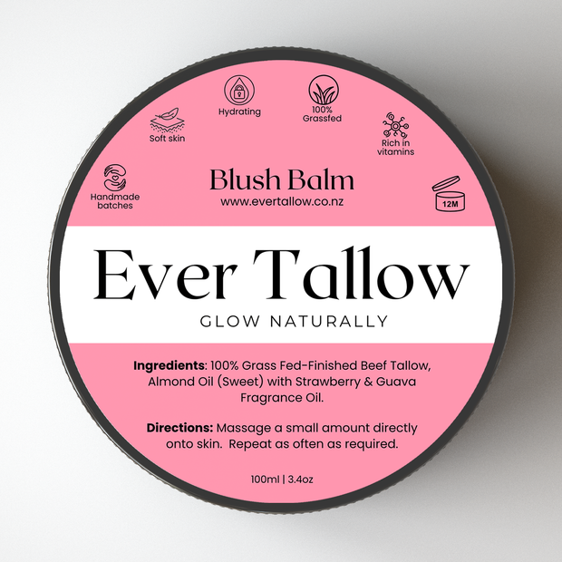 A round black-lidded jar of Blush Balm Ever Tallow fragrance oil, showing a pink and white label with product details and ingredients.
