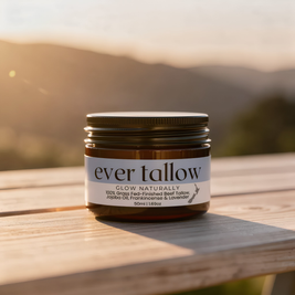 Jar of 'ever tallow' on a wooden surface with a mountainous background