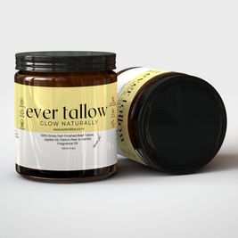 Two amber glass jars of French Pear and Vanilla Whipped Tallow on a light gray background, one standing upright showing the front label and one lying on its side showing the side label.