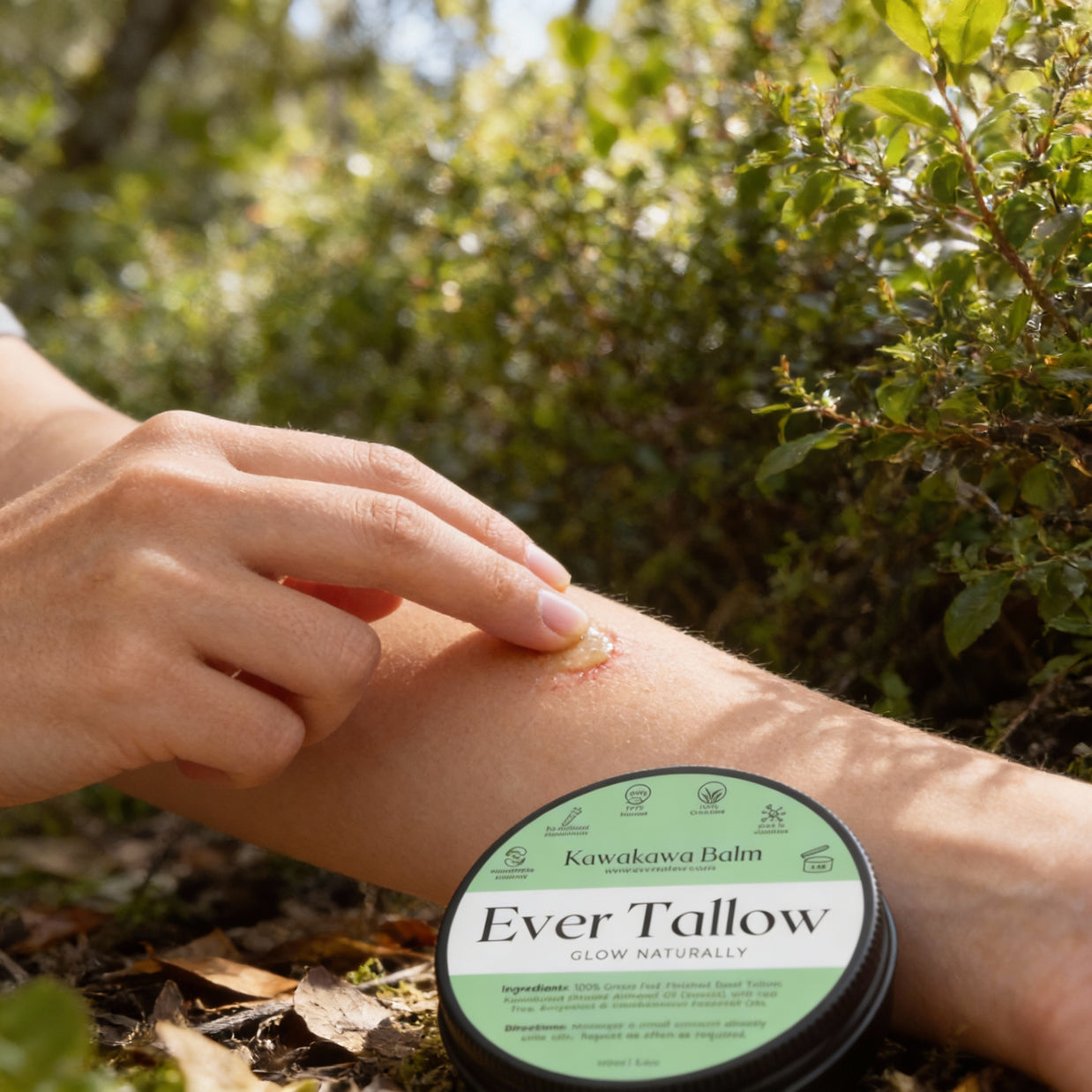 Person applying Ever Tallow balm to their arm with a natural setting in the background