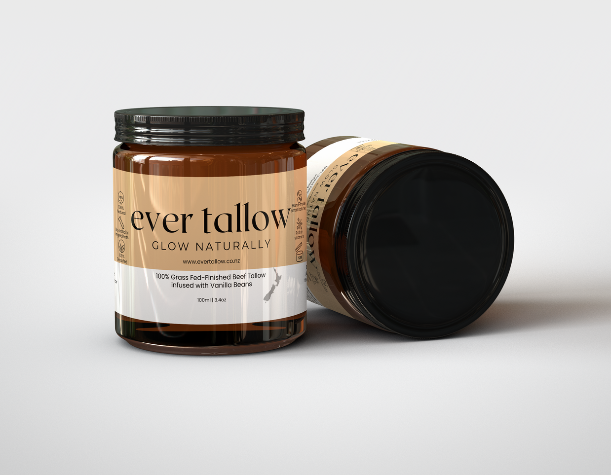 Two jars of Beef Tallow infused with Vanilla Beans.  One jar is on its side.