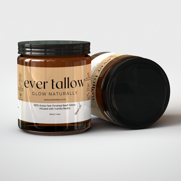 Two jars of Beef Tallow infused with Vanilla Beans.  One jar is on its side.