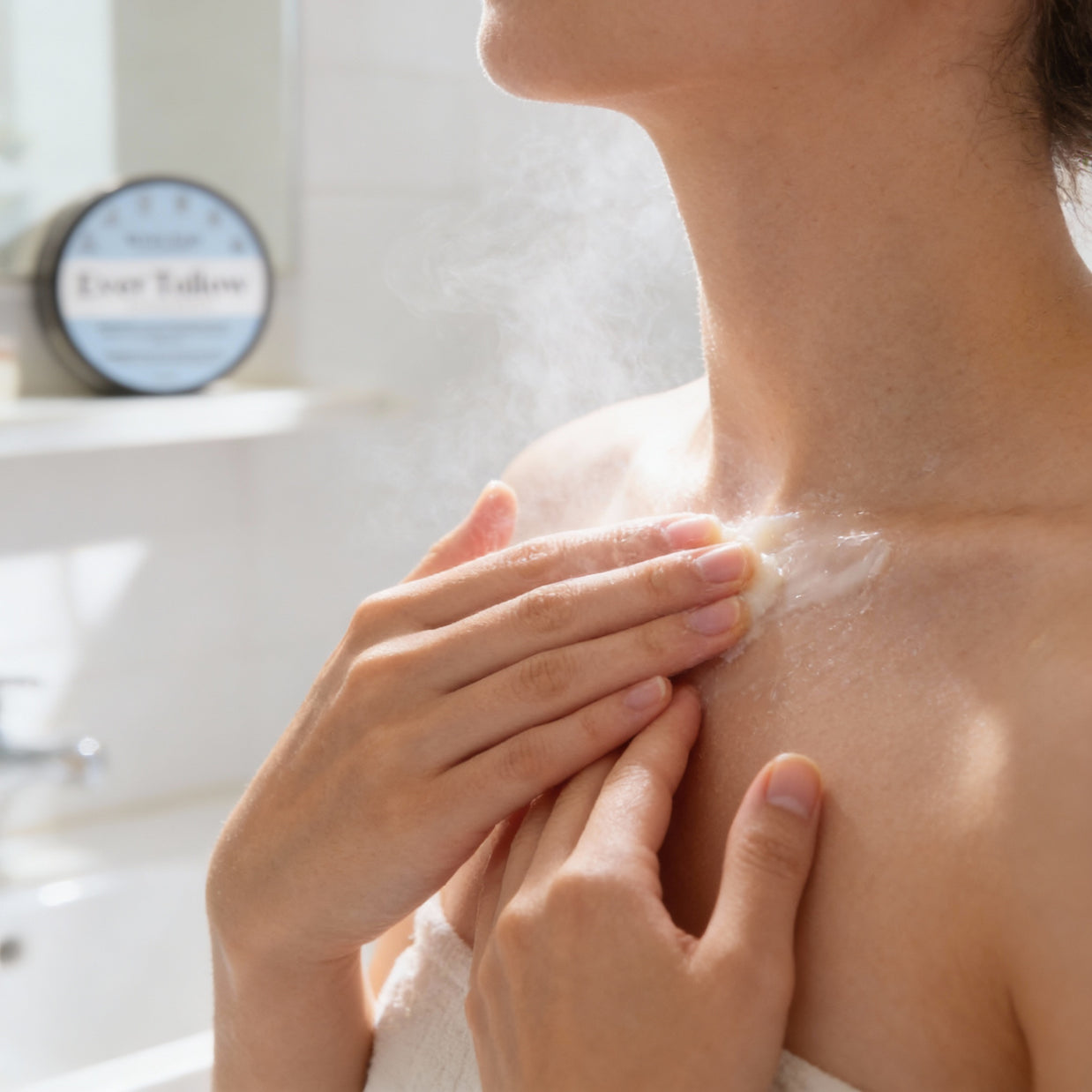 Person applying Winter Tallow Balm to their shoulder in a bathroom setting